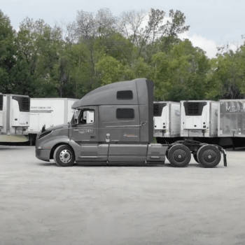 Midwest Carriers truck cab parked in fron a multiple trailers