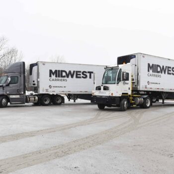 Two Midwest Carriers Trucks parked in the winter