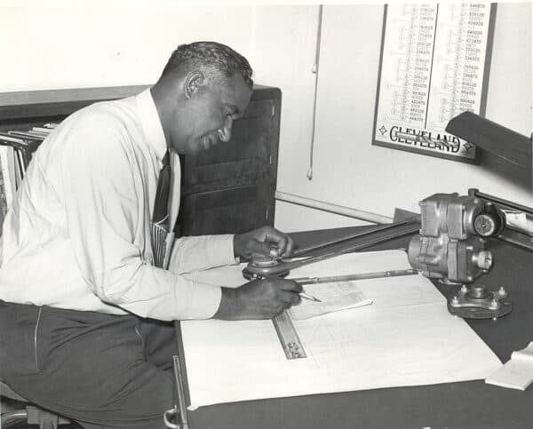 Fred McKinley Jones, innovator of mobile refrigeration trucking, works on schematics at a desk