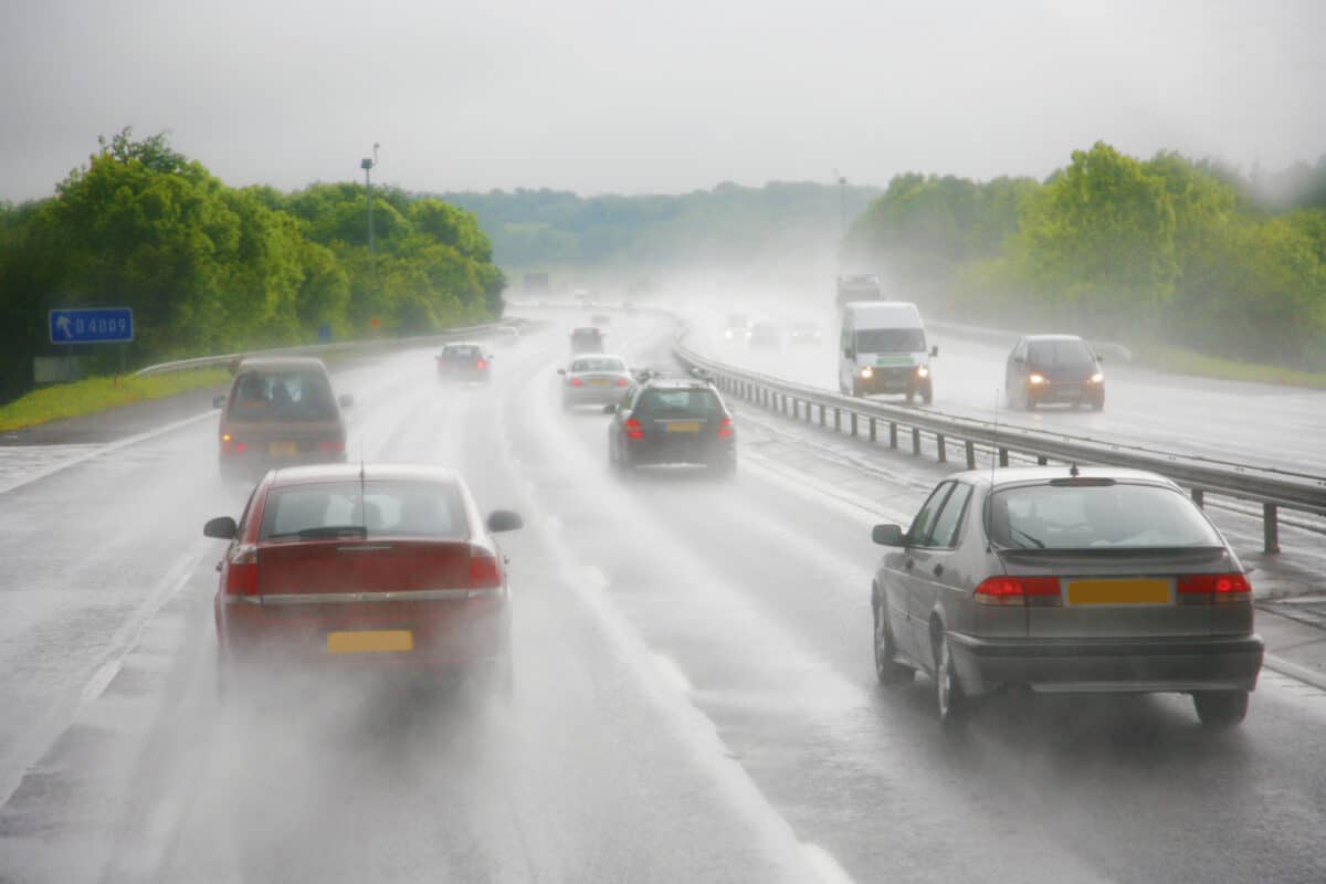Cars driving on a highway during a heavy shower