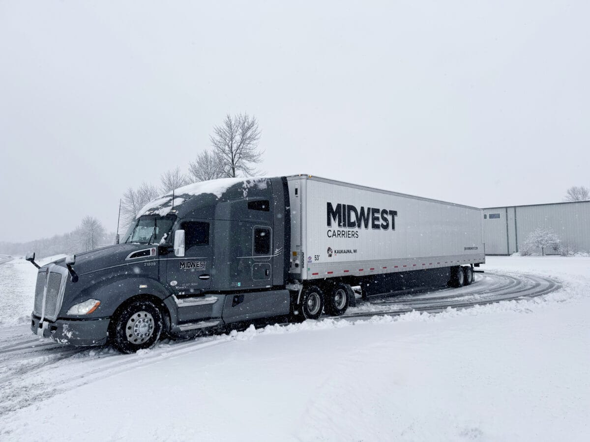 Midwest Carriers truck parked in a snowy parking lot