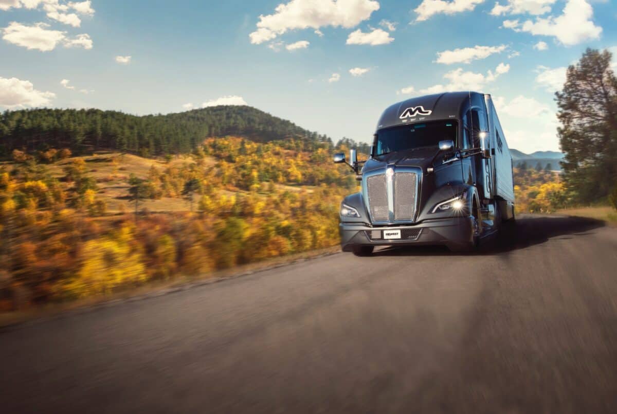 Midwest Carriers truck driving down the road through fall colors