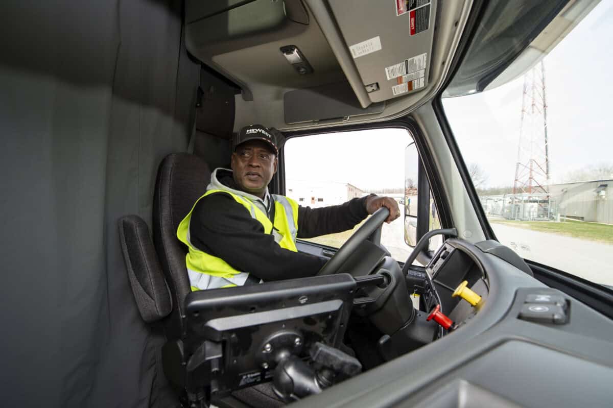 truck driver using mirrors to take a turn